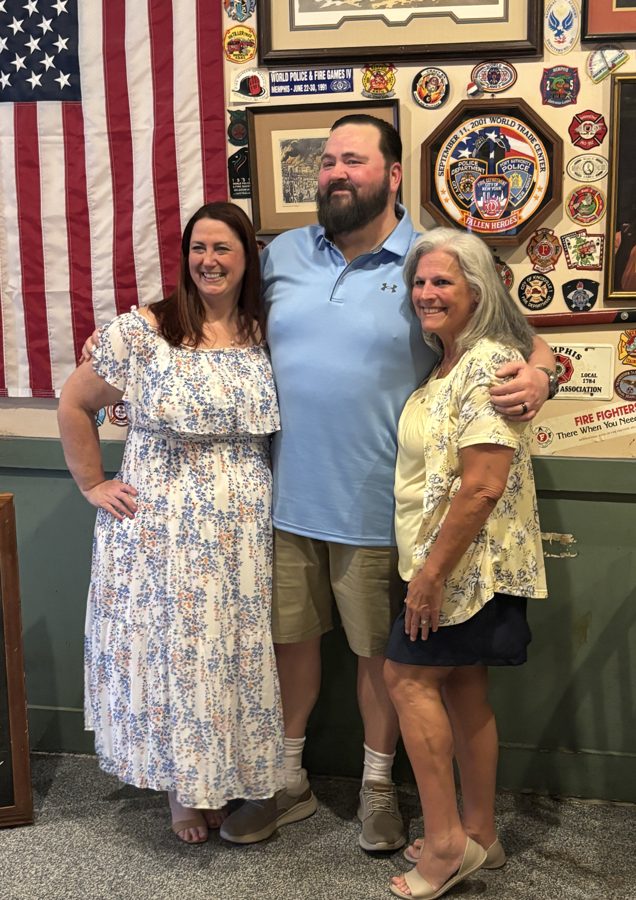 Beth with a couple on their wedding day